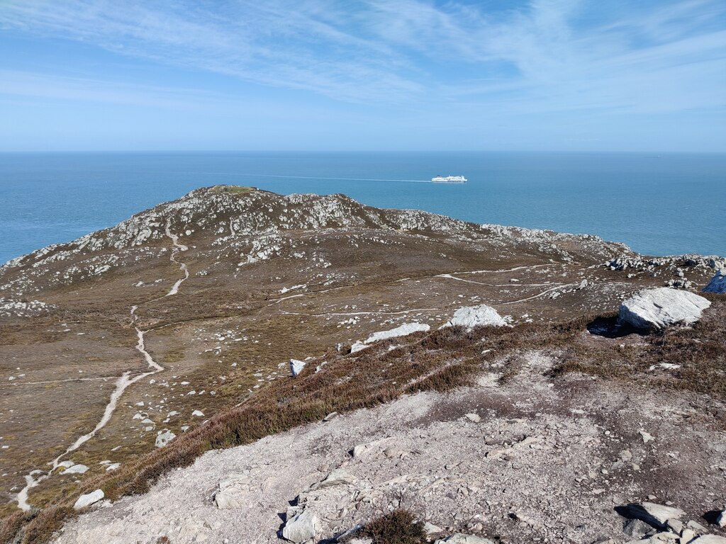The view along the cliff line from Holyhead Mountain towards North Stack (Ynys Arw) — the remote headland and old fog-station building at the edge of the walk.
